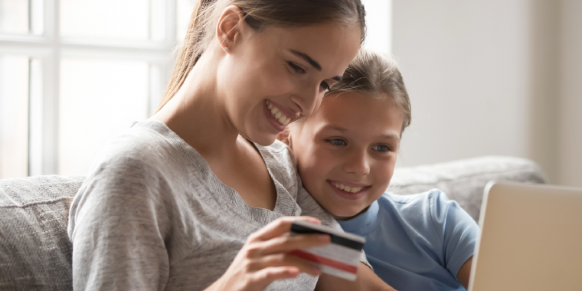 Mum and daughter looking at a card together on the couch