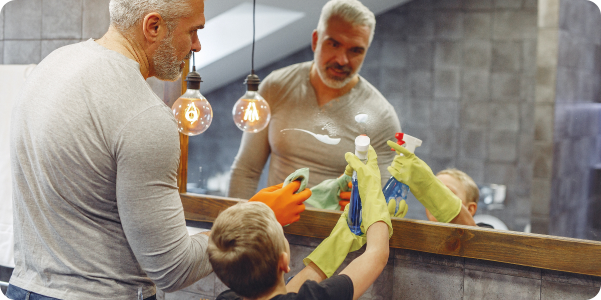 Dad and son cleaning a bathroom together