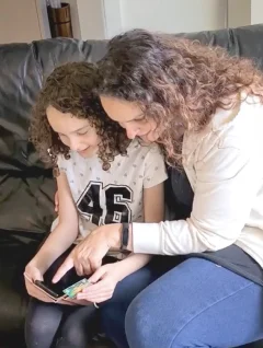 Mum and daughter using the Spriggy app on a phone