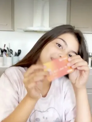 Girl holding a sunset Spriggy card